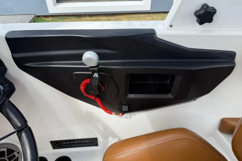 Slide: The Image of Interior of 2021 Axis T23 boat showing control panel and brown seat. - 17