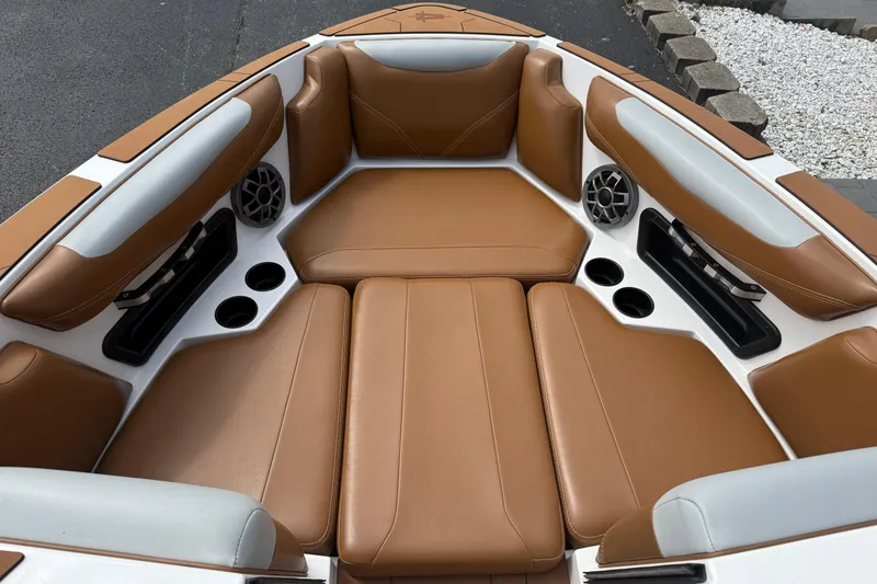 Slide: The Image of 2021 Axis T23 boat interior with tan leather seating and built-in speakers. - 21