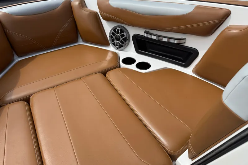 Slide: The Image of Luxurious brown leather seating in 2021 Axis T23 boat interior with speaker and cup holders. - 23