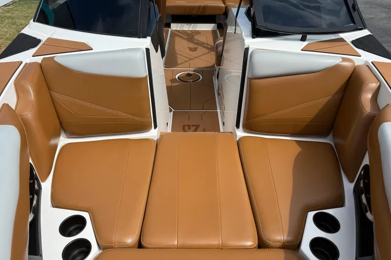 Slide: The Image of 2021 Axis T23 boat interior with tan and white seating, cup holders, and sleek design. - 25