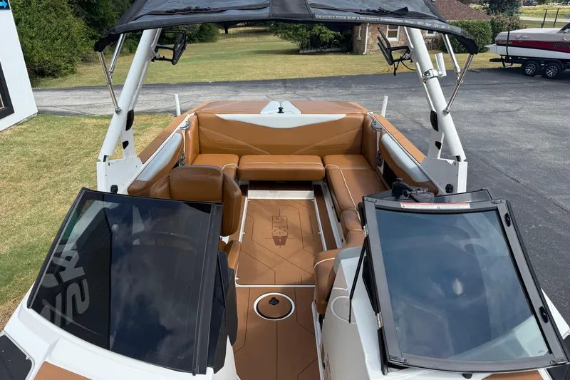 Slide: The Image of 2021 Axis T23 boat interior with tan seating and open deck view. - 26