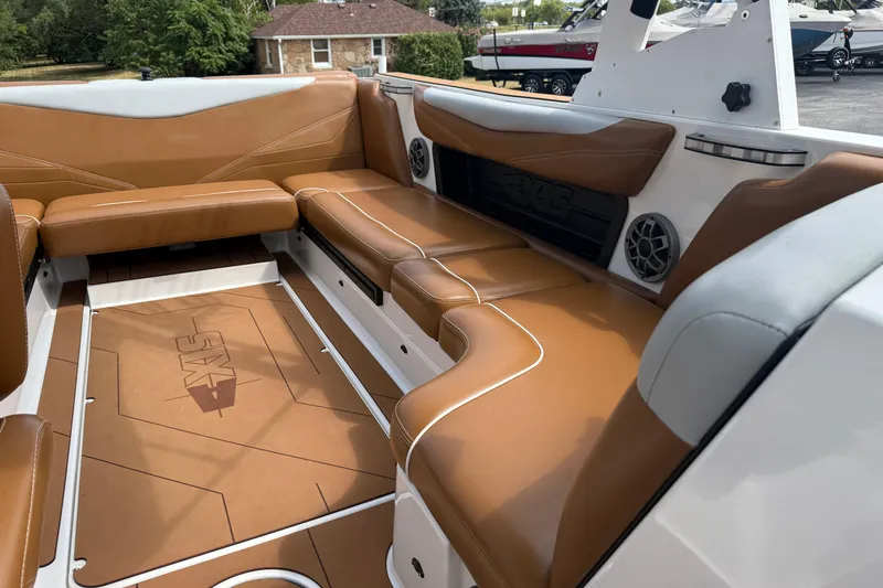 Slide: The Image of 2021 Axis T23 boat interior with brown leather seating and built-in speakers. - 29