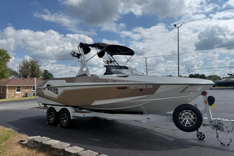 Slide: The Image of 2021 Axis T23 boat on trailer, parked outdoors under cloudy sky. - 3