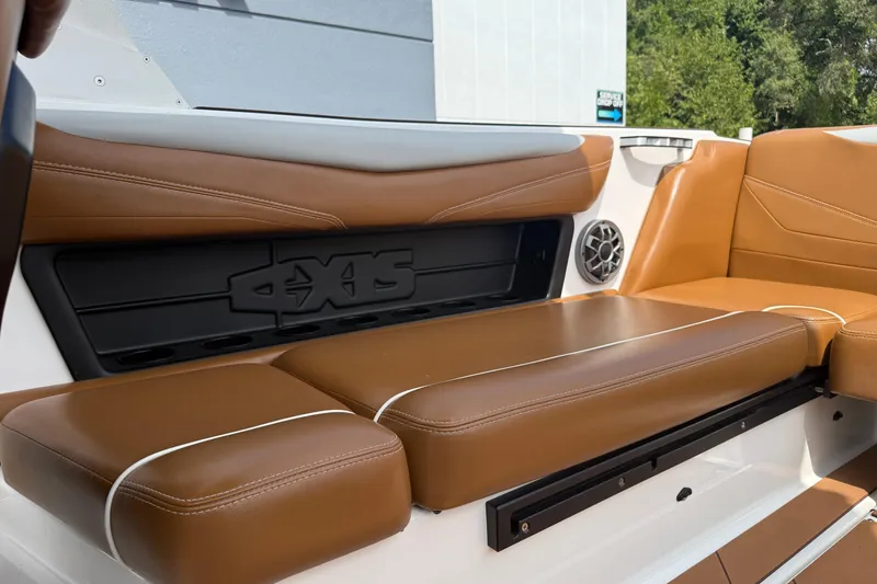 Slide: The Image of 2021 Axis T23 boat interior with brown leather seating and speaker detail. - 32