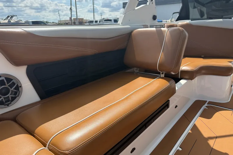 Slide: The Image of Interior of 2021 Axis T23 boat with brown leather seating and speaker. - 33