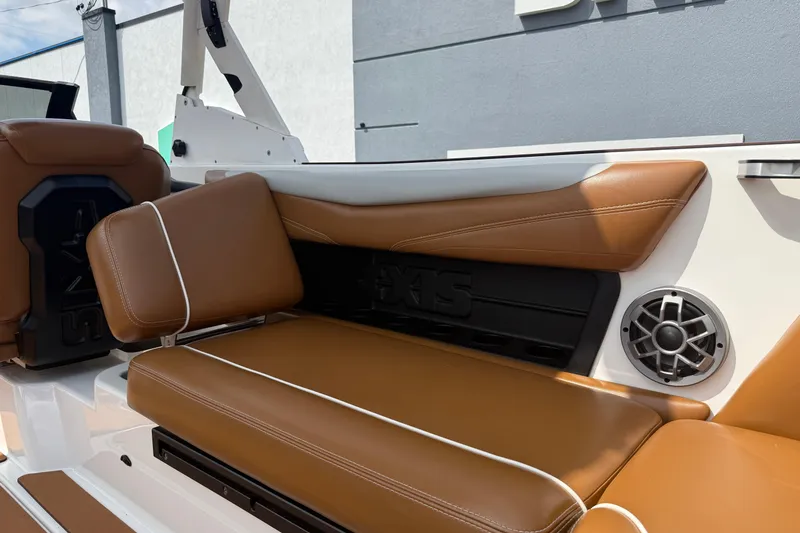 Slide: The Image of 2021 Axis T23 boat interior with brown leather seats and speaker detail. - 34