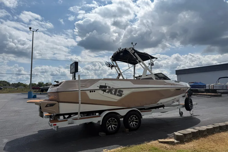 Slide: The Image of 2021 Axis T23 boat on trailer under cloudy sky in parking lot. - 5