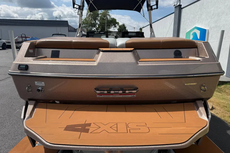Slide: The Image of 2021 Axis T23 boat rear view with brown seating and swim platform. - 8