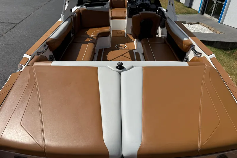 Slide: The Image of 2021 Axis T23 boat interior with tan and white seating, showcasing spacious design. - 9