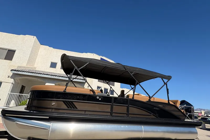 The Image of 2026 Bennington 24 MSL pontoon boat on trailer, displayed outdoors under clear sky. - 0