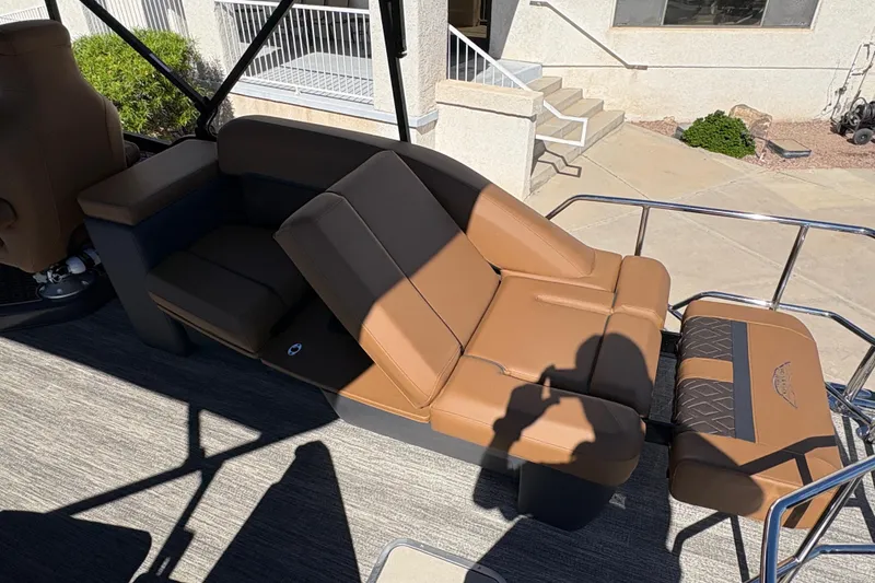 Slide: The Image of 2026 Bennington 24 MSL boat interior with brown seating and modern design. - 17