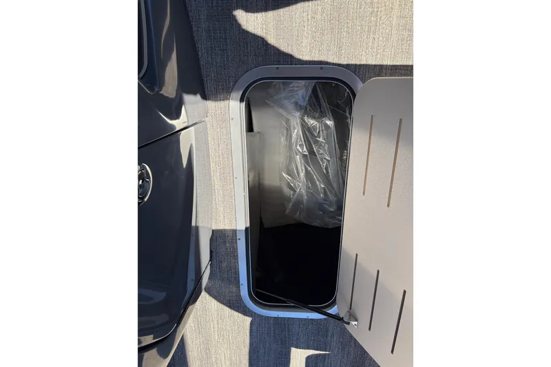 Slide: The Image of 2026 Bennington 24 MSL boat interior with tan seating and fold-out table. - 23