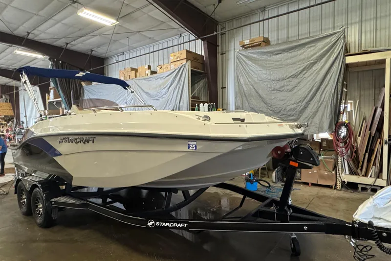 Slide: The Image of 2023 Starcraft SVX 191 OB boat on trailer in a warehouse setting. - 1