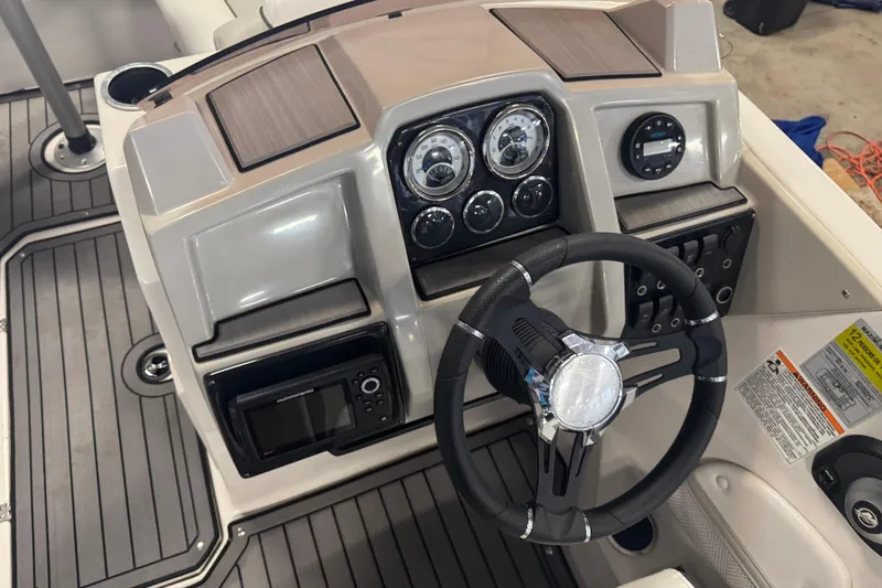 Slide: The Image of 2023 Starcraft SVX 191 OB boat dashboard with steering wheel and control panel. - 11