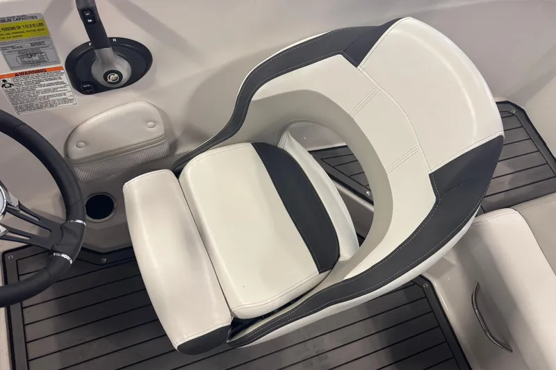 Slide: The Image of 2023 Starcraft SVX 191 OB boat interior with steering wheel and cushioned seat. - 13