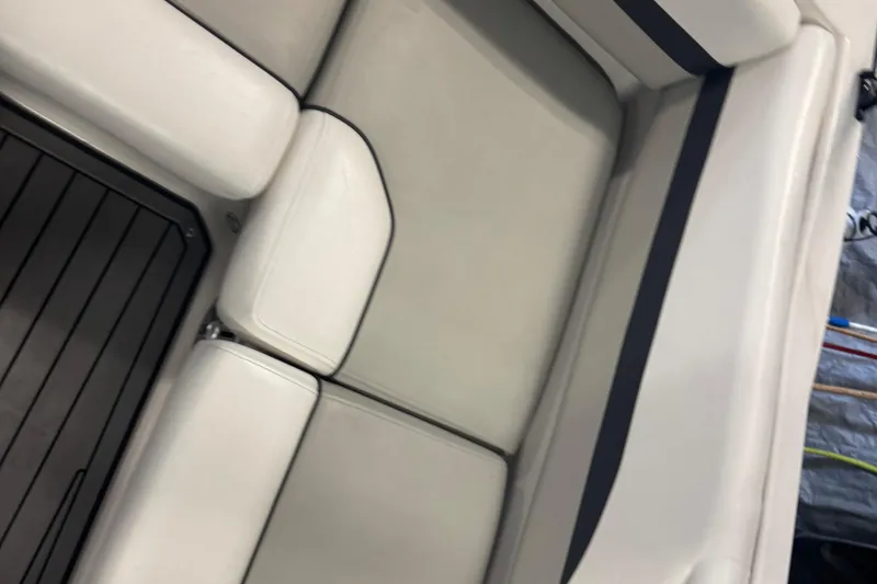 Slide: The Image of 2023 Starcraft SVX 191 OB boat interior with white cushioned seating and dark flooring. - 14