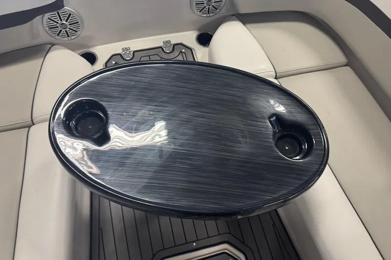 Slide: The Image of 2023 Starcraft SVX 191 OB boat interior with oval table and cup holders. - 7