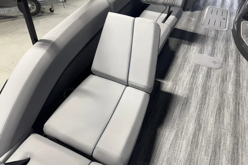 Slide: The Image of 2026 Bennington 24 MSL boat interior with sleek gray seating and flooring. - 16