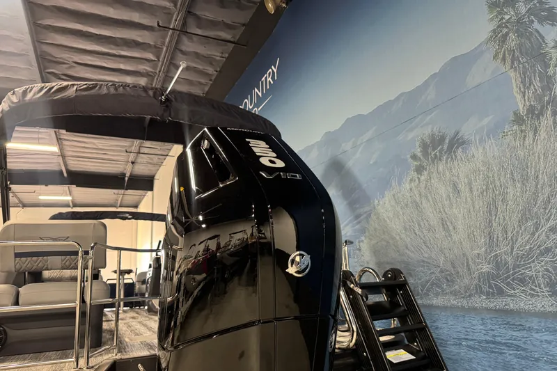 Slide: The Image of 2026 Bennington 24 MSL boat with powerful outboard motor in showroom setting. - 5