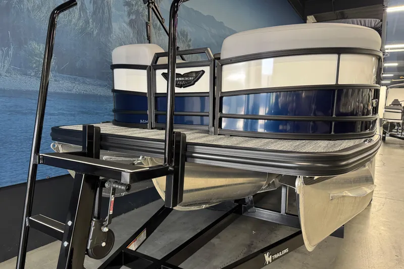 Slide: The Image of 2026 Bennington 24 MSL pontoon boat on trailer in showroom setting. - 7