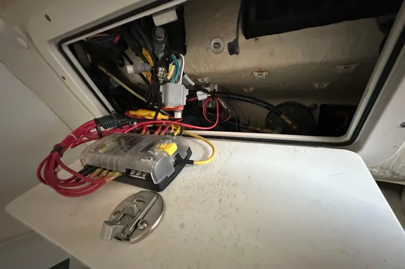 Slide: The Image of Electrical wiring and components inside a 2021 World Cat 230 SD boat compartment. - 101