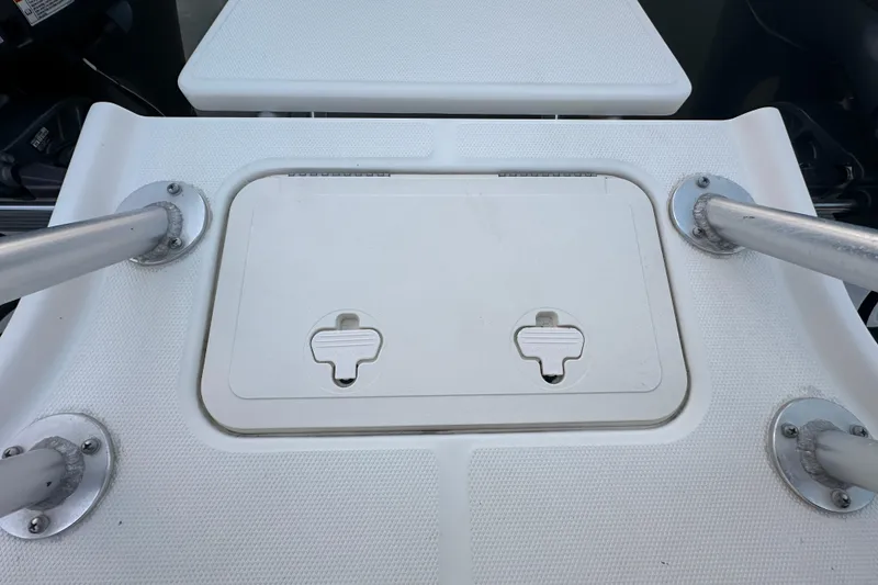 Slide: The Image of 2021 World Cat 230 SD boat deck with storage hatch and metal supports. - 102