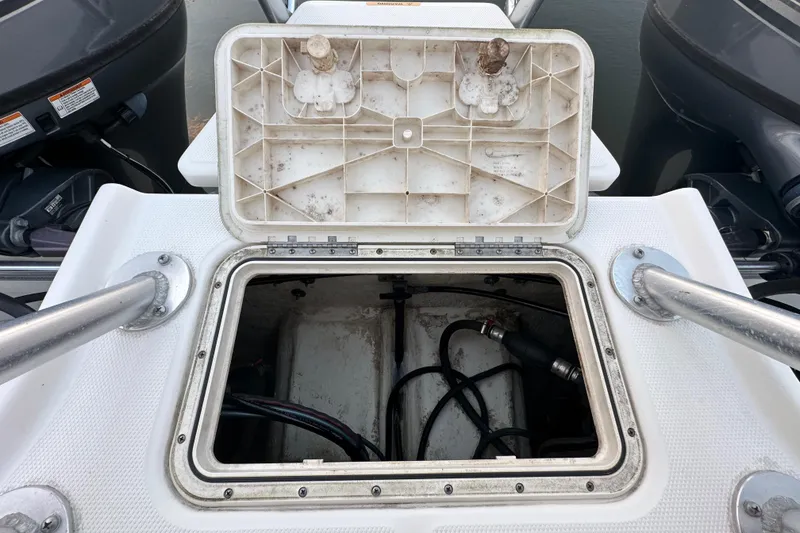 Slide: The Image of Open hatch on 2021 World Cat 230 SD boat, revealing internal wiring and components. - 103