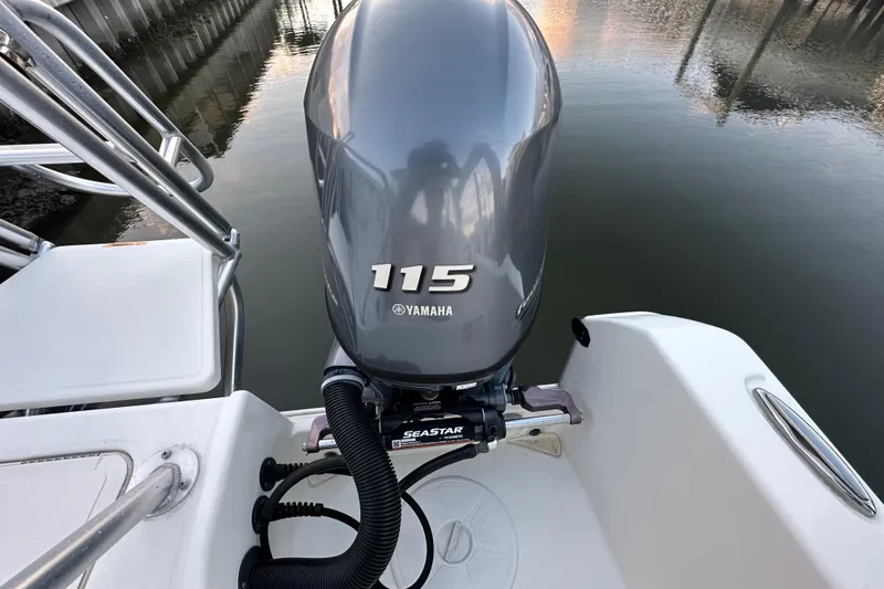 Slide: The Image of 2021 World Cat 230 SD boat with Yamaha 115 outboard motor on calm water. - 107