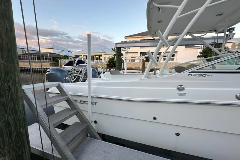 Slide: The Image of 2021 World Cat 230 SD boat docked, featuring sleek design and dual Yamaha engines. - 109