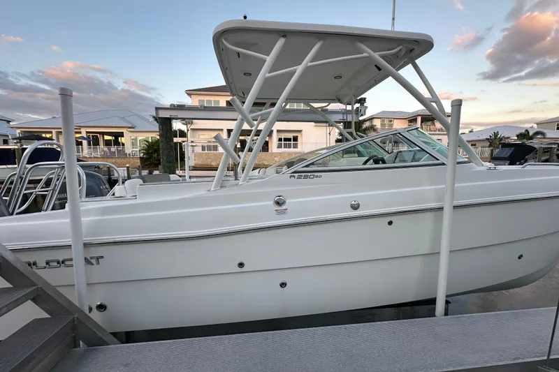 Slide: The Image of 2021 World Cat 230 SD boat docked at marina during sunset. - 110