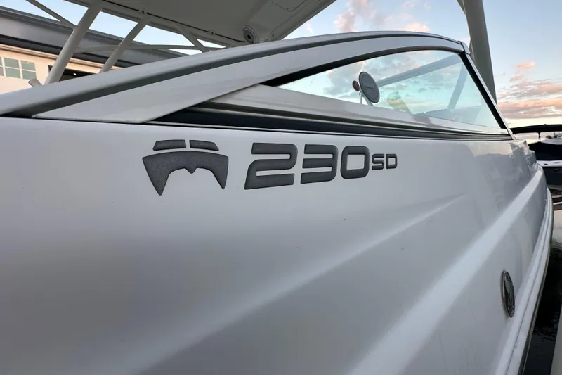 Slide: The Image of 2021 World Cat 230 SD boat side view with logo and sleek design. - 112