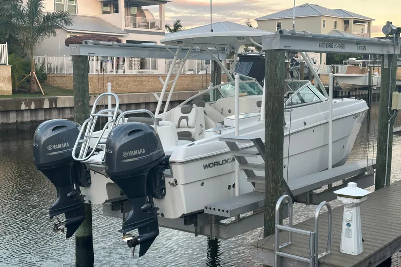 Slide: The Image of 2021 World Cat 230 SD boat with twin Yamaha engines docked at marina. - 113