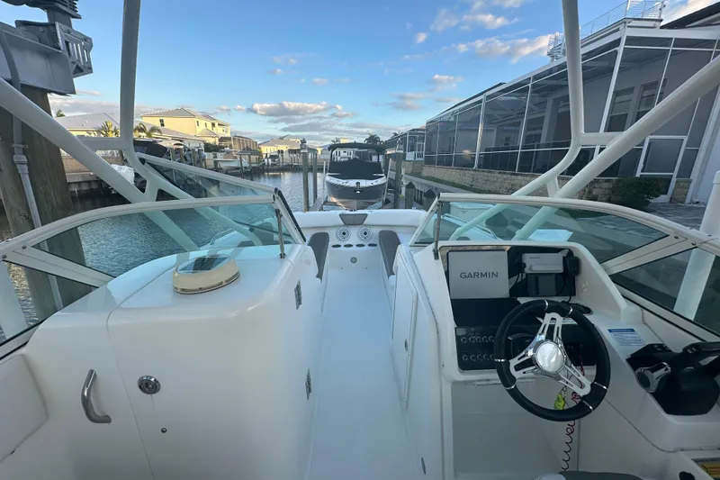 Slide: The Image of 2021 World Cat 230 SD boat interior with Garmin navigation, docked in a marina. - 16