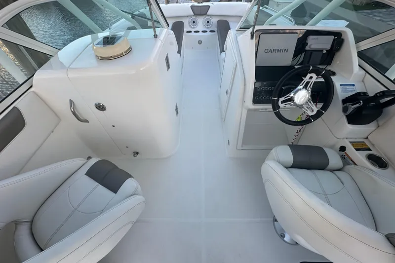 Slide: The Image of 2021 World Cat 230 SD boat interior with steering wheel and seating. - 17