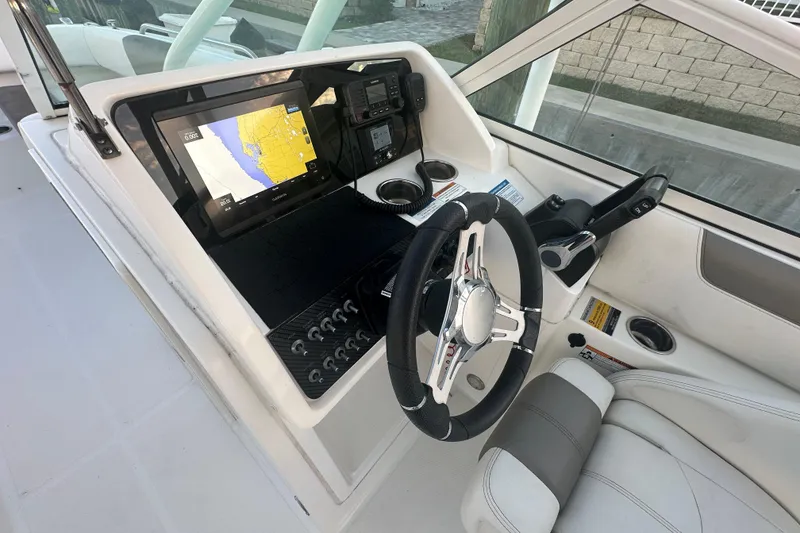 Slide: The Image of Cockpit of 2021 World Cat 230 SD with navigation display and steering wheel. - 20