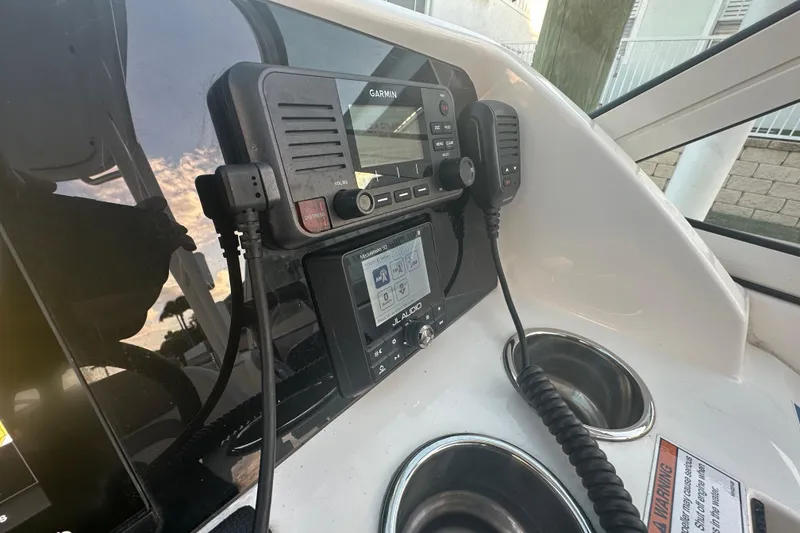 Slide: The Image of Control panel of 2021 World Cat 230 SD boat with Garmin electronics and audio system. - 22