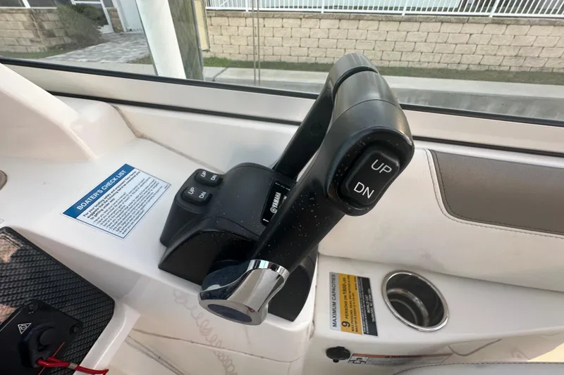 Slide: The Image of Throttle control lever on a 2021 World Cat 230 SD boat dashboard. - 28
