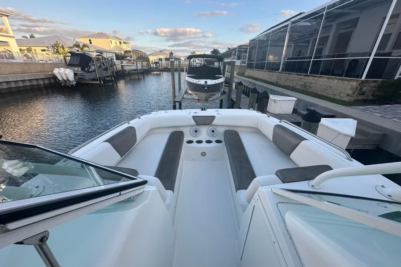 Slide: The Image of 2021 World Cat 230 SD boat docked in a marina, featuring spacious seating. - 30