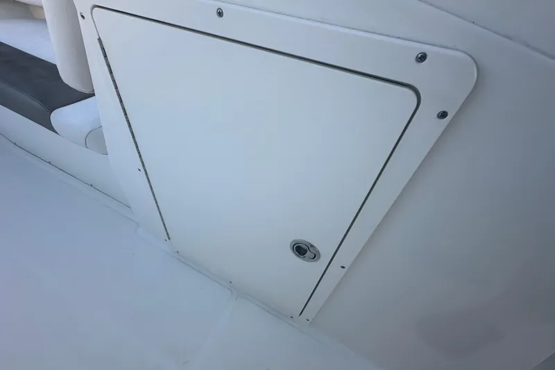 Slide: The Image of 2021 World Cat 230 SD boat storage compartment with sleek white finish. - 32