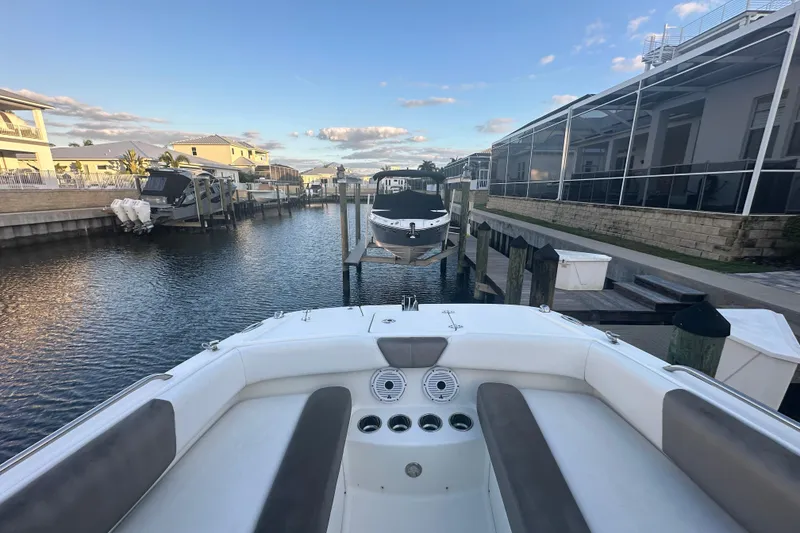 Slide: The Image of 2021 World Cat 230 SD boat docked in a residential canal setting. - 33