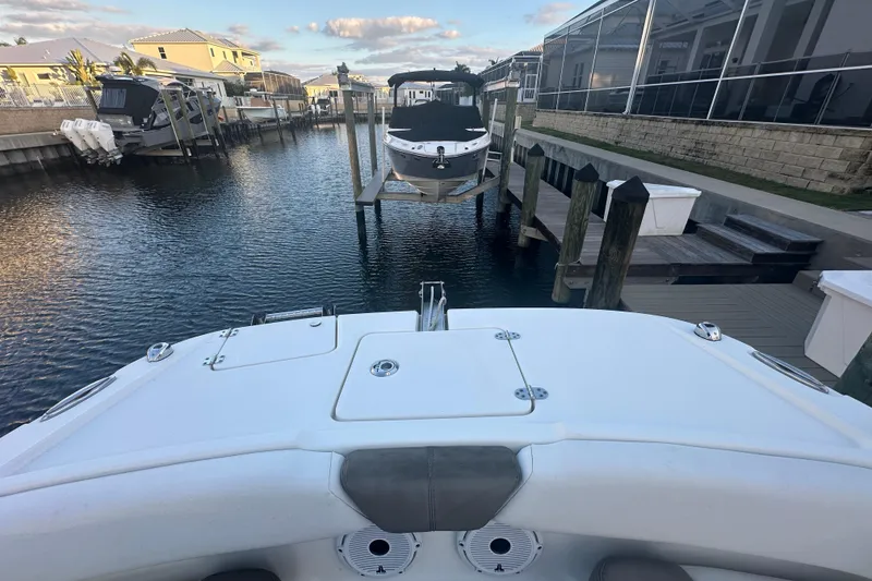 Slide: The Image of 2021 World Cat 230 SD boat docked in a residential canal setting. - 36