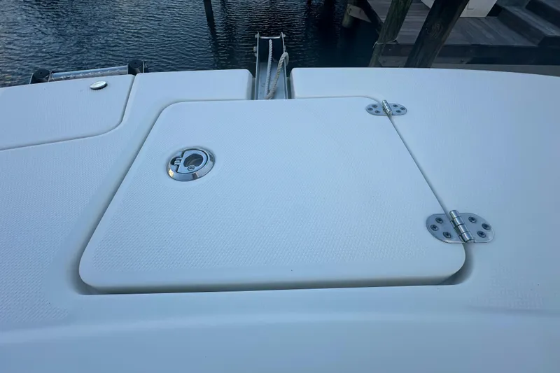 Slide: The Image of 2021 World Cat 230 SD boat deck with hatch and hinges, dockside view. - 38