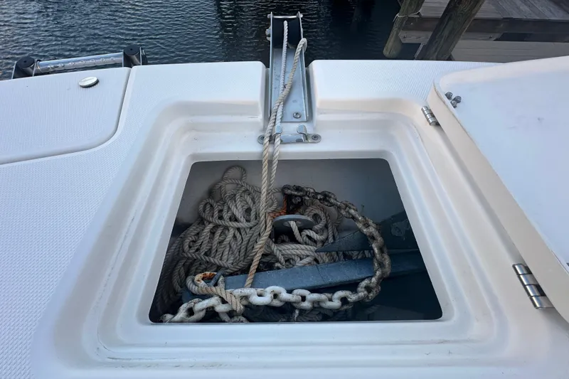Slide: The Image of Anchor storage compartment on 2021 World Cat 230 SD boat with rope and chain. - 39