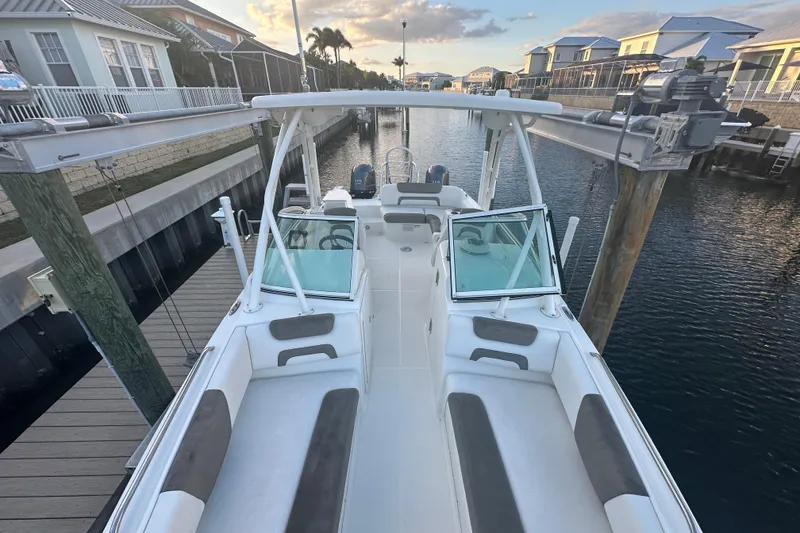 Slide: The Image of 2021 World Cat 230 SD boat docked in a scenic waterfront setting. - 41