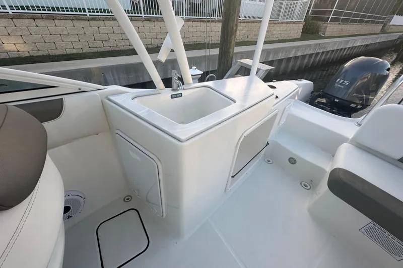 Slide: The Image of 2021 World Cat 230 SD boat interior with sink and seating area. - 60