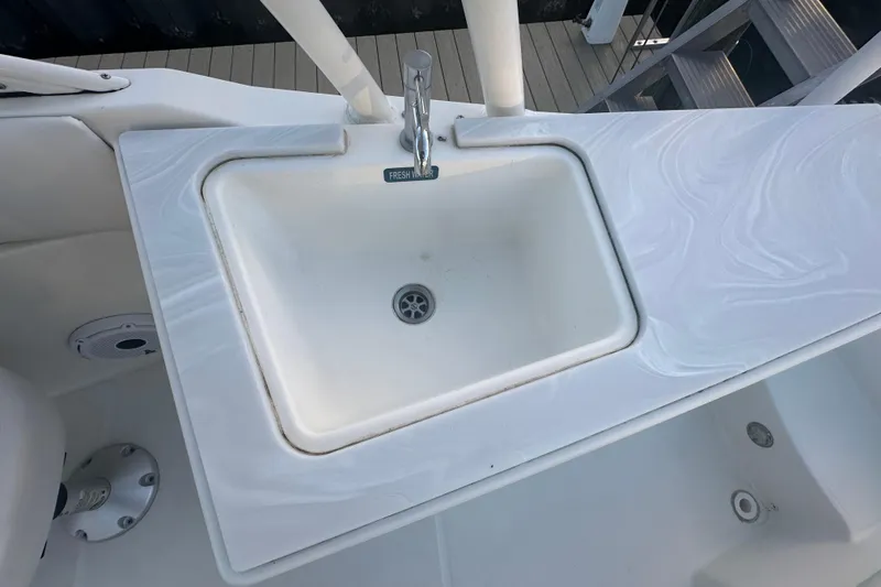 Slide: The Image of 2021 World Cat 230 SD boat sink with fresh water faucet on deck. - 62