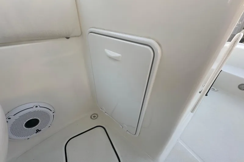 Slide: The Image of 2021 World Cat 230 SD boat interior with speaker and storage compartment. - 63
