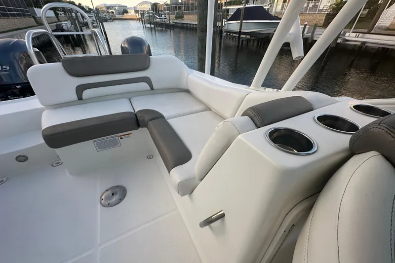 Slide: The Image of 2021 World Cat 230 SD boat interior with cushioned seating and cup holders. - 65