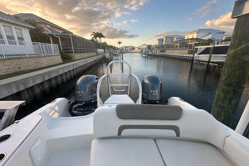 Slide: The Image of World Cat 230 SD boat with dual Yamaha 115 engines docked in a scenic canal. - 67