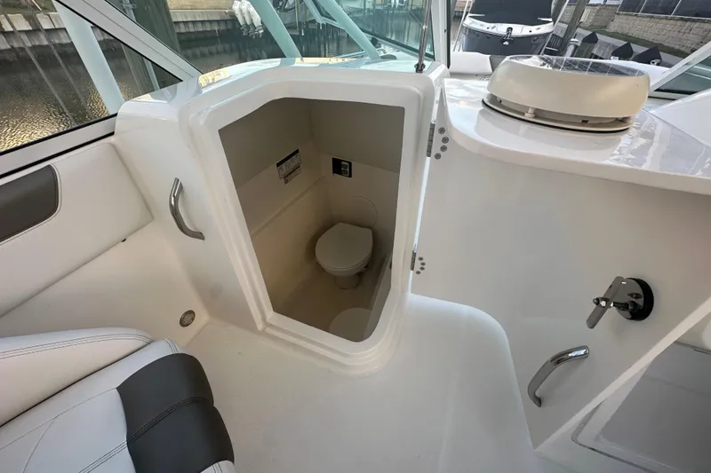 Slide: The Image of 2021 World Cat 230 SD boat interior with compact marine toilet. - 70